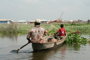 family on a boat in a swamp in Benin benin visa for us citizens