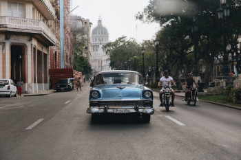 classic car driving through Cuban streets