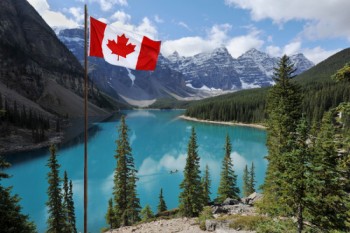 Mountains and lake with a Canadian flag