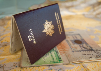 Passport and visa over a map